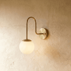 Clérachic wall lamp in chrome, a frosted glass globe suspended beneath a curved gooseneck arm.