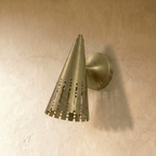 Clérachic wall lamp in brushed brass viewed from the side, showing the cone shade's rounded wall mount.