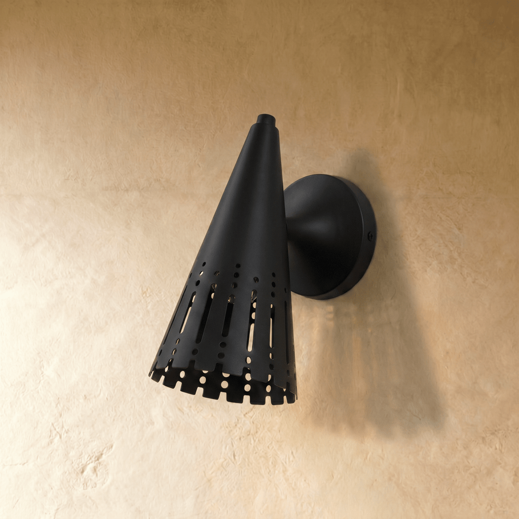 Clérachic wall lamp in matte black shown at an angle, the perforated shade catching soft highlights.