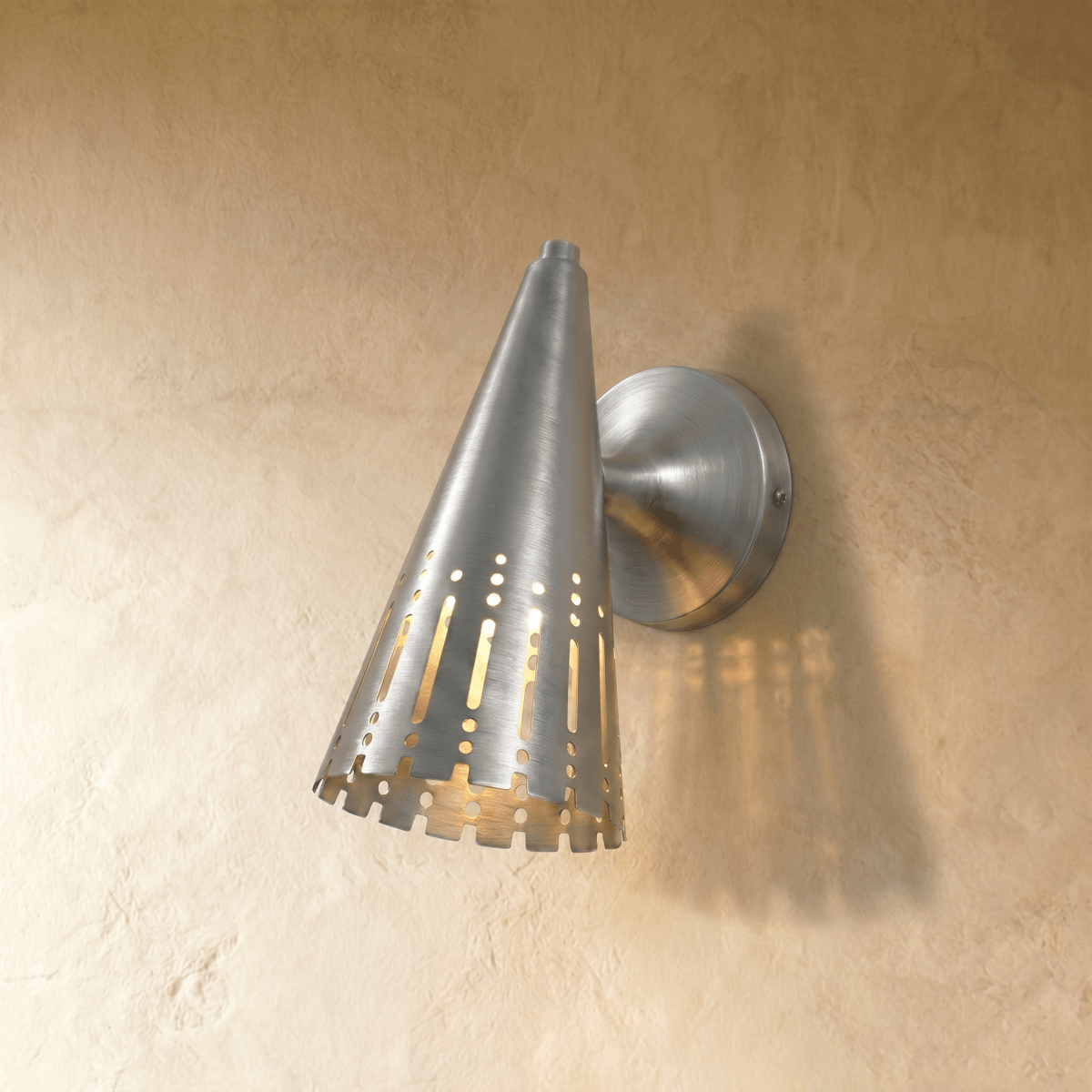 Clérachic wall lamp in chrome, the polished cone shade and dome mount reflecting a cool metallic sheen.