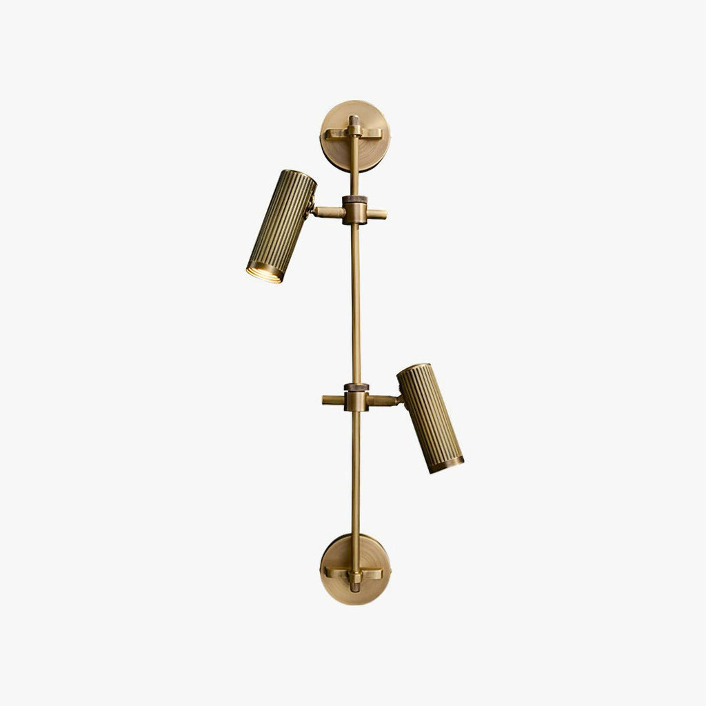 Two-head wall light from Clérachic in a bronze finish, with fluted cylinder spotlights on a slim vertical rail, on a plain white backdrop.