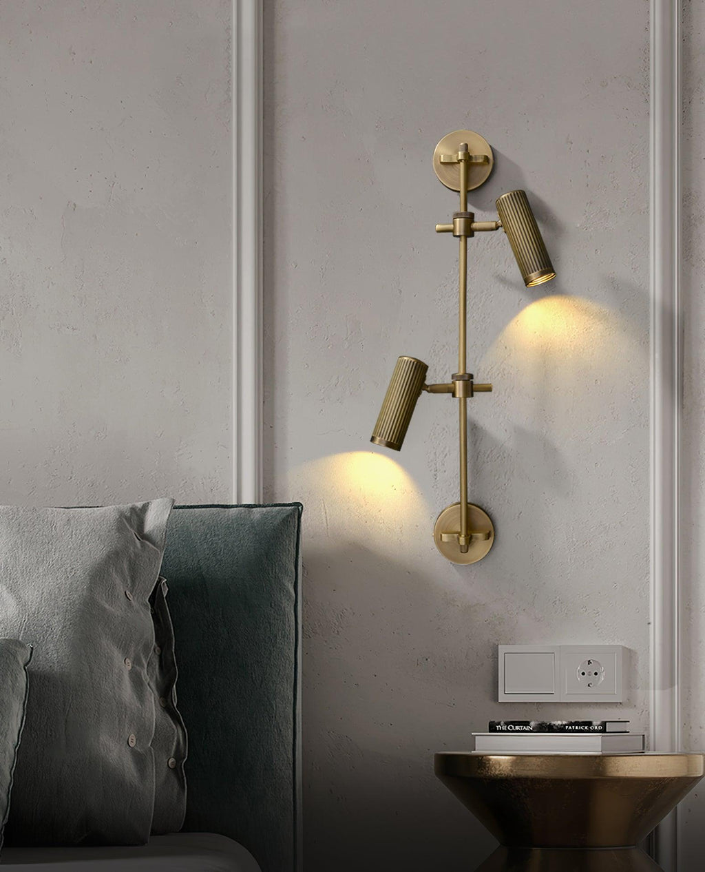 Two-head wall light from Clérachic beside a bed, with both fluted heads aimed down to light the wall panelling and a bedside table.