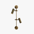 Two-head bronze wall light from Clérachic with both heads angled down, on a light grey backdrop.