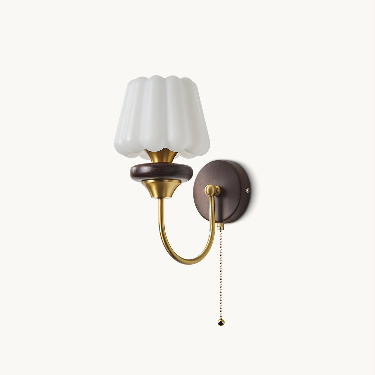White fluted glass shade on a curved brass arm with a walnut-toned ring and round backplate, from Clérachic, with a ball-tipped pull chain.