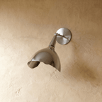 Clérachic wall lamp in chrome shown from another angle, the swivel arm catching a cool metallic sheen.
