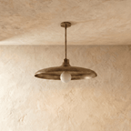 Clérachic pendant light in vintage brass, the disc shade and drop rod viewed from a slightly different angle.