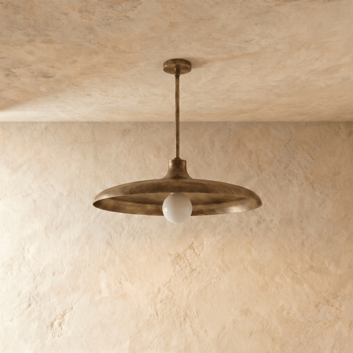 Clérachic pendant light in vintage brass, the disc shade and drop rod viewed from a slightly different angle.