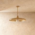 Clérachic pendant light in polished brass, the disc shade and drop rod shown from another angle.
