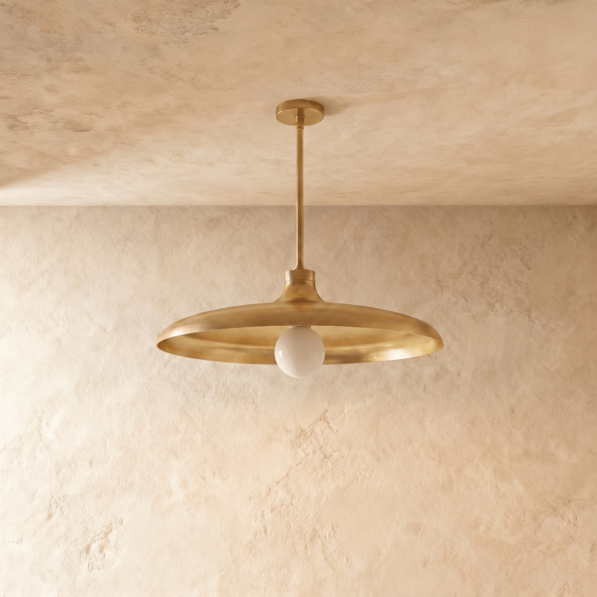 Clérachic pendant light in polished brass, the disc shade and drop rod shown from another angle.
