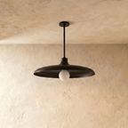 Clérachic pendant light in matte black, the disc shade and drop rod shown from another angle.