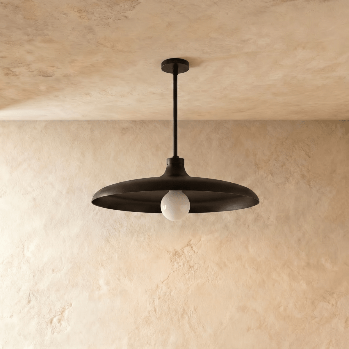 Clérachic pendant light in matte black, the disc shade and drop rod shown from another angle.