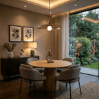 Clérachic vintage brass pendant light glowing above a round oak table beside glazed doors opening to a garden.