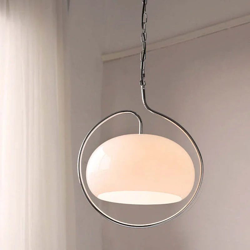 Clérachic white frosted glass dome pendant encircled by a thin chrome halo against a beige wall.