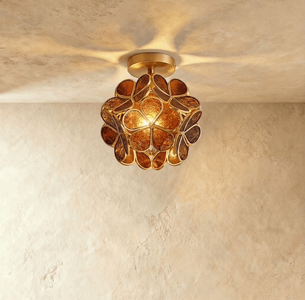 Clérachic flower ceiling light in amber glass petals with an embossed floral pattern, glowing warm overhead.
