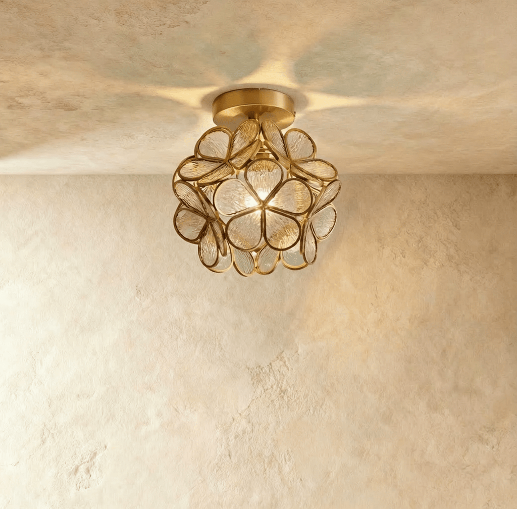 Clérachic flower ceiling light in clear ribbed glass petals on a brass mount, lit warm overhead.