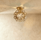 Clérachic flower ceiling light in clear ribbed glass petals on a brass mount, lit warm overhead.