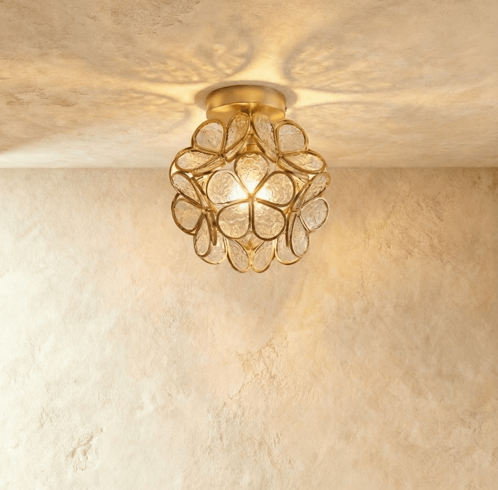 Clérachic flower ceiling light in clear glass petals with an embossed floral pattern, glowing bright and warm.