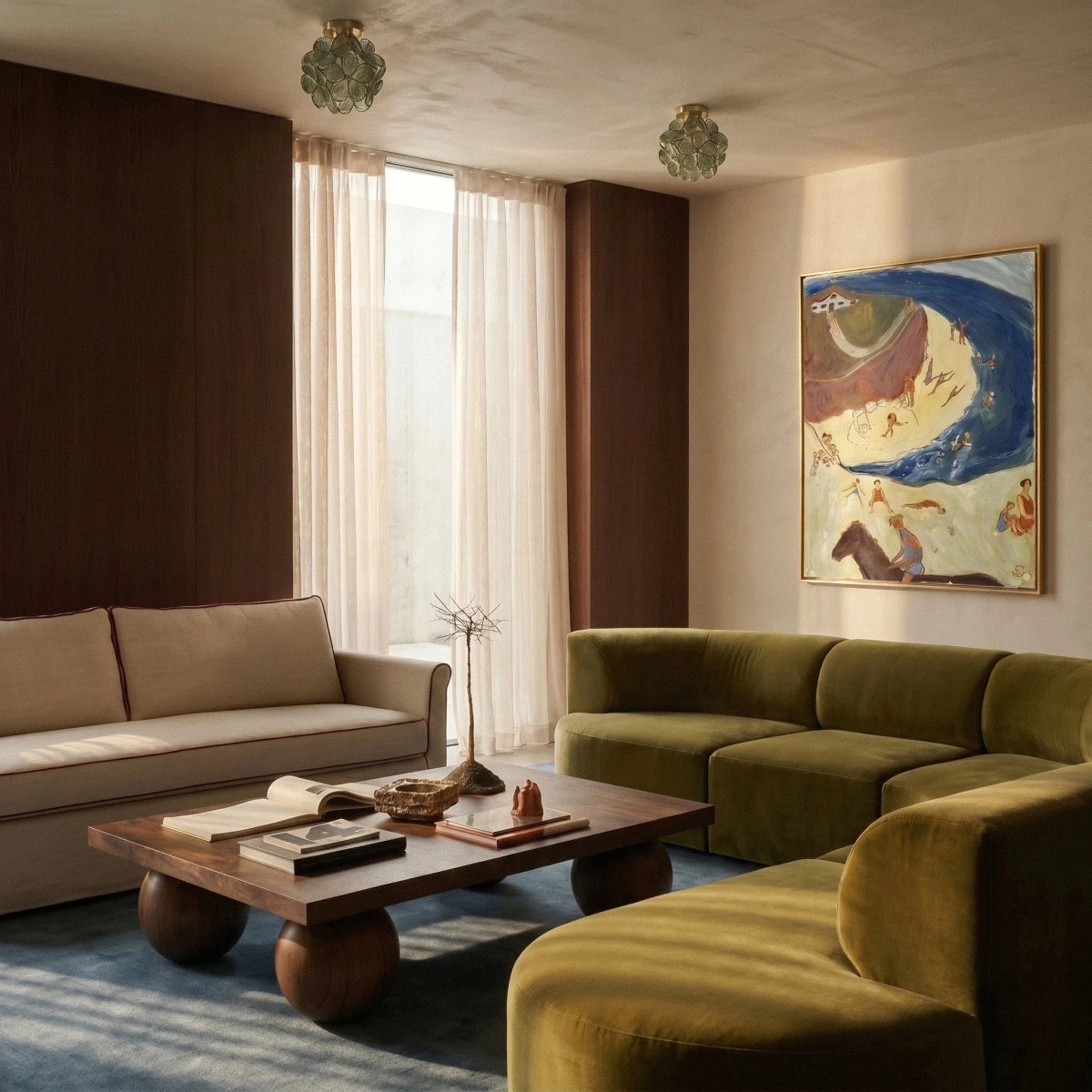 Two Clérachic flower ceiling lights in sage green glow warm above a living room with an olive sectional.