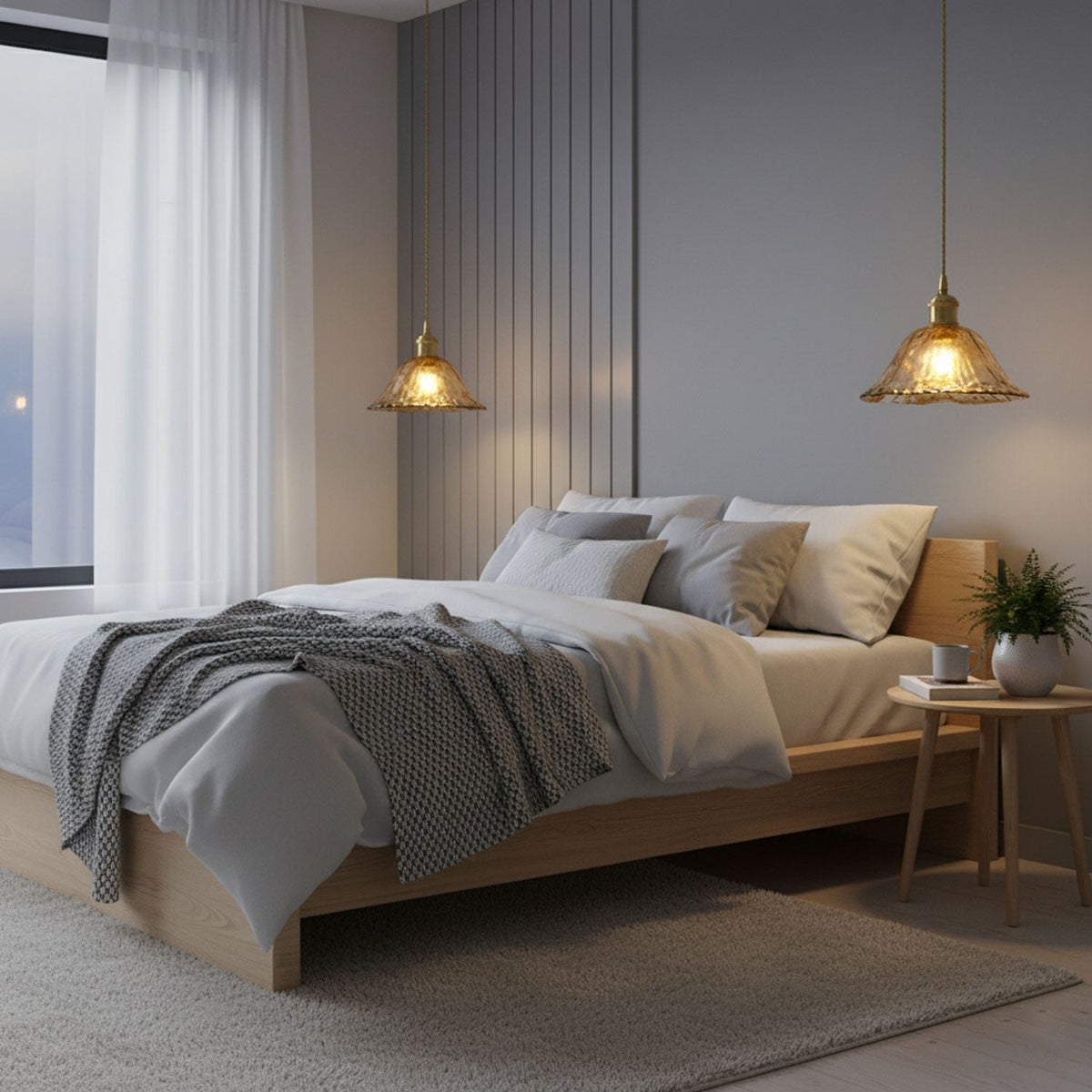 Two Clérachic glass pendants glowing on either side of a bed with a grey throw, in a softly lit bedroom with a slatted wall panel.