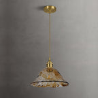 Unlit Clérachic bell-shaped pendant with a brass ceiling plate against a grey wall, its rippled brown glass edge lightly frilled.