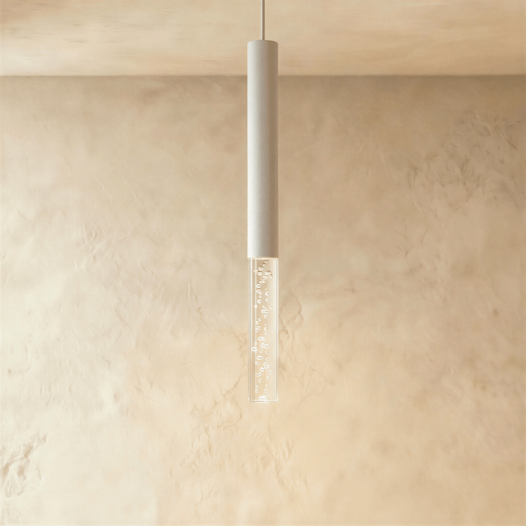 Clérachic white aluminium pendant light with a short clear bubble acrylic shade, hanging in front of a limewash wall.