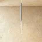 Clérachic slim white cylinder pendant with a clear acrylic shade of sparkling bubbles against a soft plaster wall.