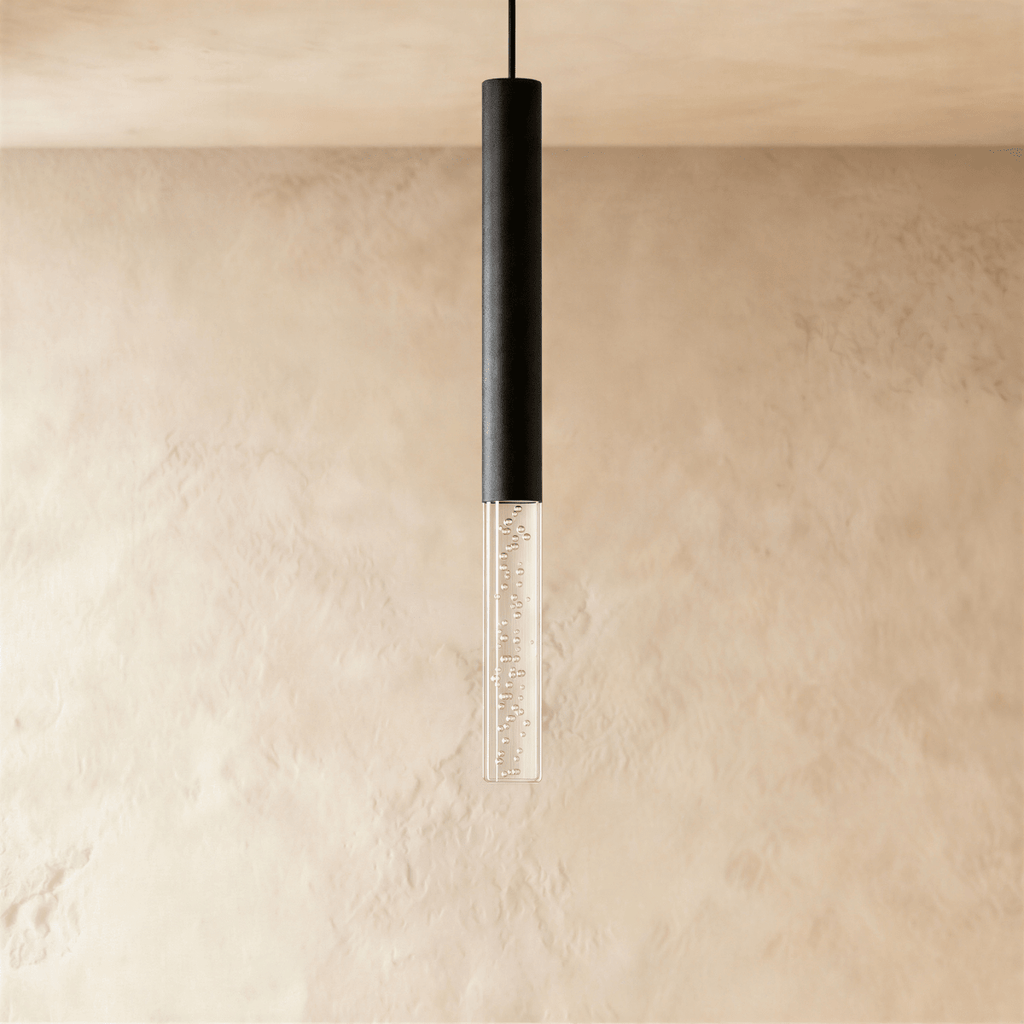 Clérachic black cylindrical pendant light with a short clear acrylic shade of fine bubbles, on a limewash wall.