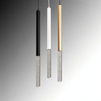 Clérachic bubble acrylic pendants in black, white and gold, hanging side by side against a grey studio backdrop.
