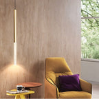 Clérachic gold pendant light with a bubble acrylic shade beside a mustard armchair and a small side table.