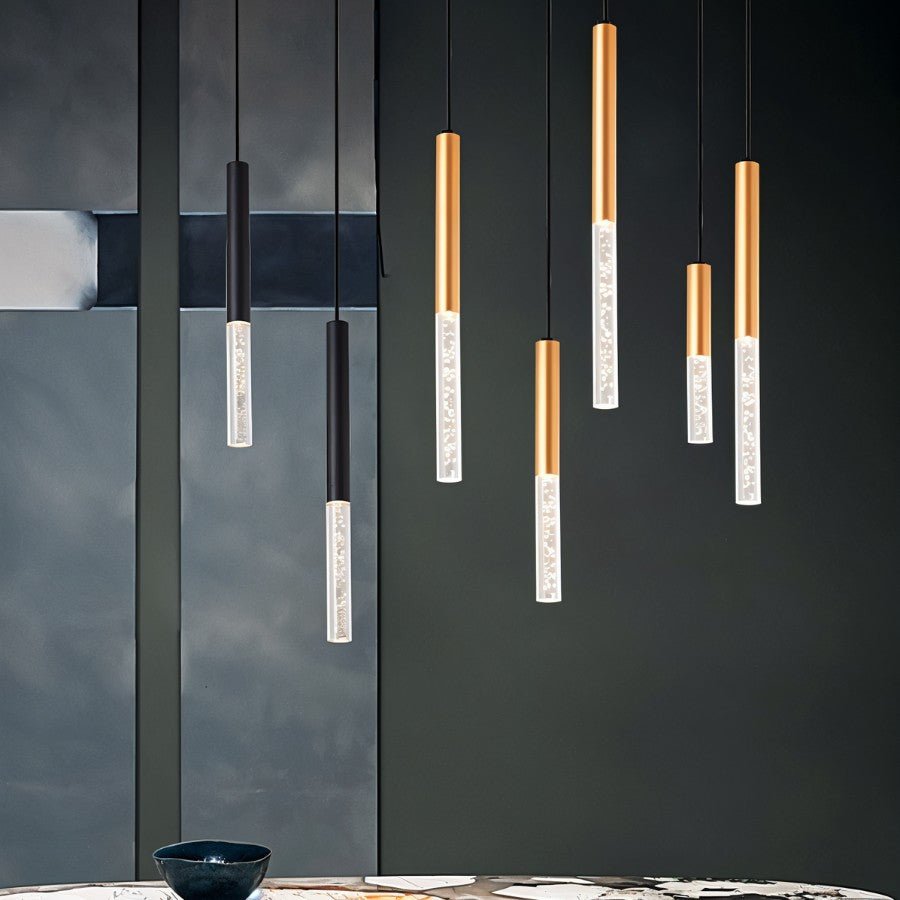 Clérachic pendants in black and gold with bubble acrylic shades, hung at varied heights over a dark dining room.