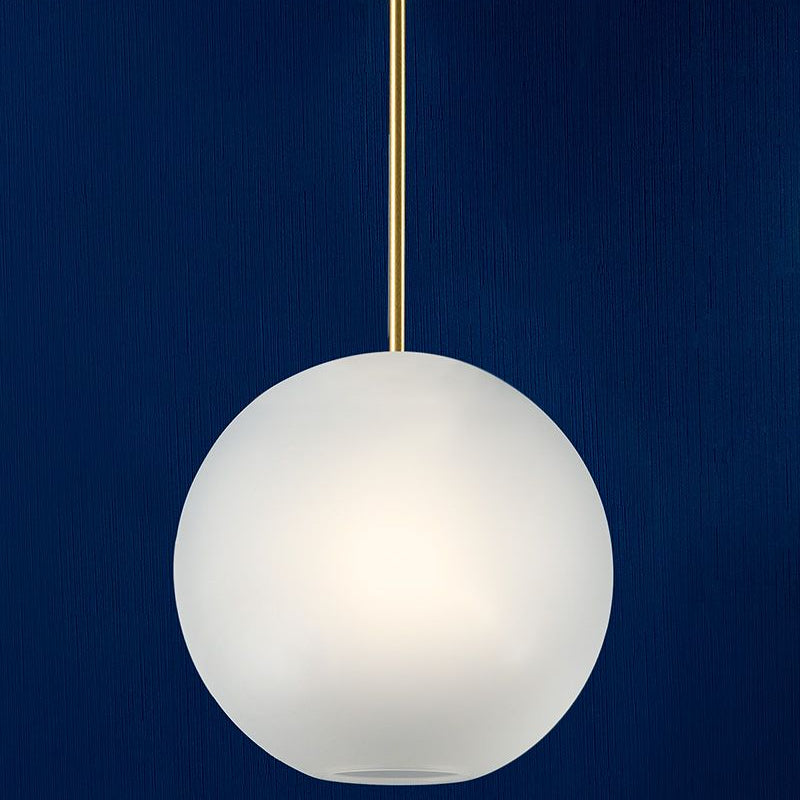 The Clérachic Bubble Cluster Pendant Light's frosted-glass globe glowing warm white against a deep navy wall.