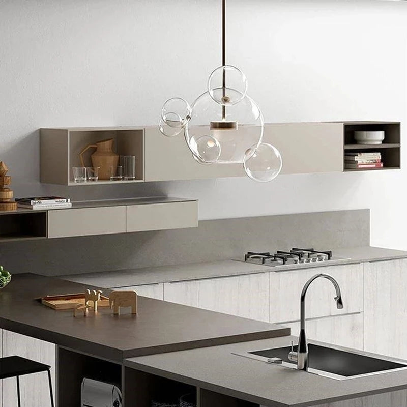 The Clérachic Bubble Cluster Pendant Light's 4-head clear-glass cluster hanging above a kitchen island counter.