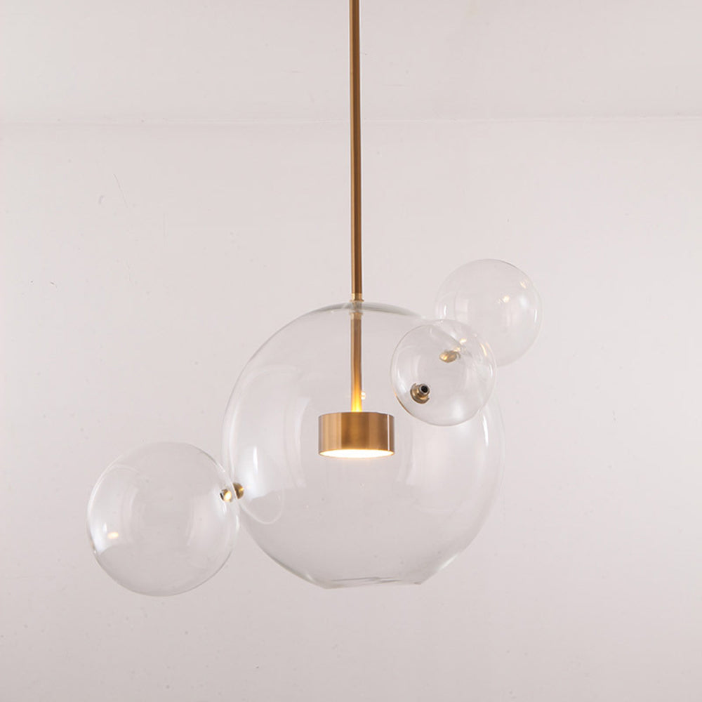 The Clérachic Bubble Cluster Pendant Light's 4-head clear-glass cluster, angled to show its satellite bubbles and brass fittings.