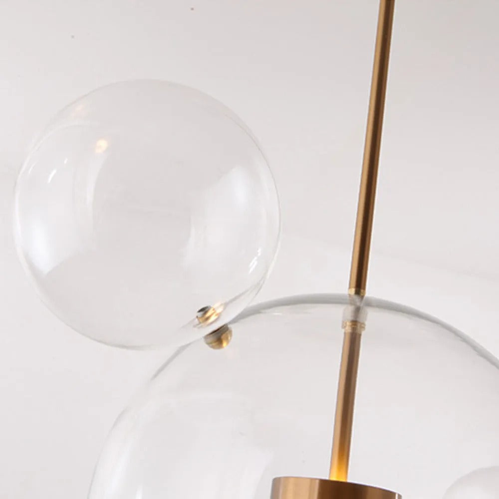 Close-up of a satellite bubble's ball-and-post fitting on the Clérachic Bubble Cluster Pendant Light's clear-glass main globe.