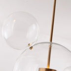 Close-up of a satellite bubble's ball-and-post fitting on the Clérachic Bubble Cluster Pendant Light's clear-glass main globe.