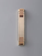 Unlit rose gold wall light from Clérachic on a pale grey wall, its crystal bar flecked with tiny bubbles.