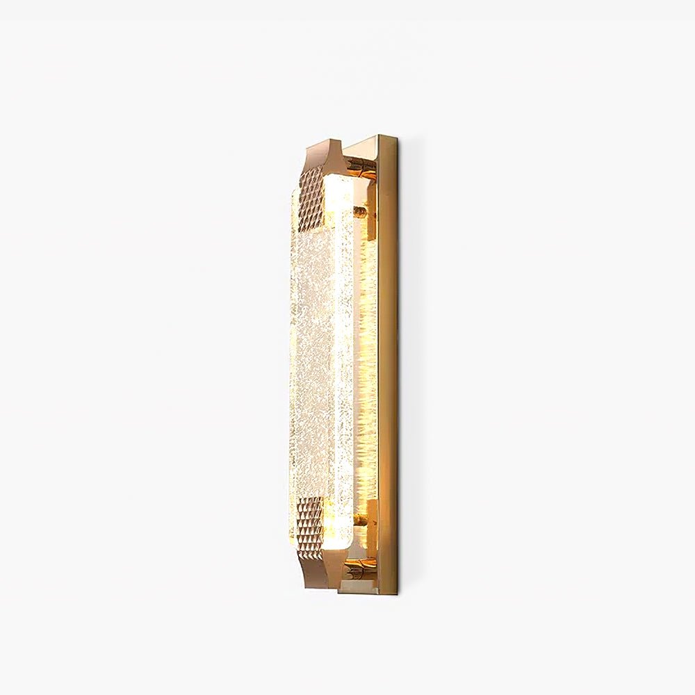 Angled view of a Clérachic wall light on white, its bubbled crystal glowing softly between two textured rose gold caps.