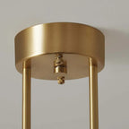 Close-up of the Clérachic pendant's round brass-tone ceiling canopy, showing the mounting screws and rigid support rods.