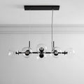 Black Clérachic bubble glass linear pendant light with eight staggered clear globes, mounted on a white ceiling with crown molding.