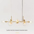 Studio display of the gold-body Clérachic bubble glass pendant with all eight clear glass globes lit.
