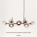 Studio display of the black-body Clérachic bubble glass pendant with all eight smoke gray globes lit.