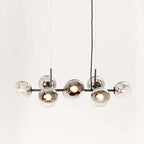 Black-body Clérachic bubble glass pendant with smoke gray globes, photographed on a seamless white studio backdrop.