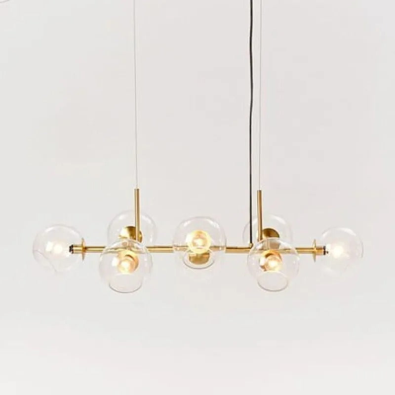 Gold-body Clérachic bubble glass pendant with clear glass globes, photographed straight-on against white.