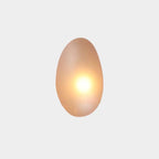 Amber Clérachic Bubble Glass Wall Sconce in the tall egg shape, its warm bulb blooming dead centre and turning the glass honey-gold.