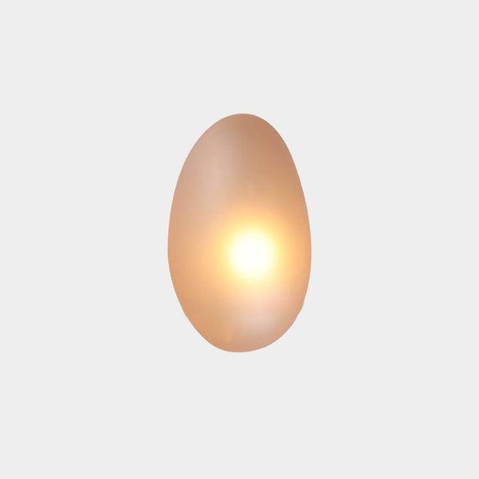 Amber Clérachic Bubble Glass Wall Sconce in the tall egg shape, its warm bulb blooming dead centre and turning the glass honey-gold.