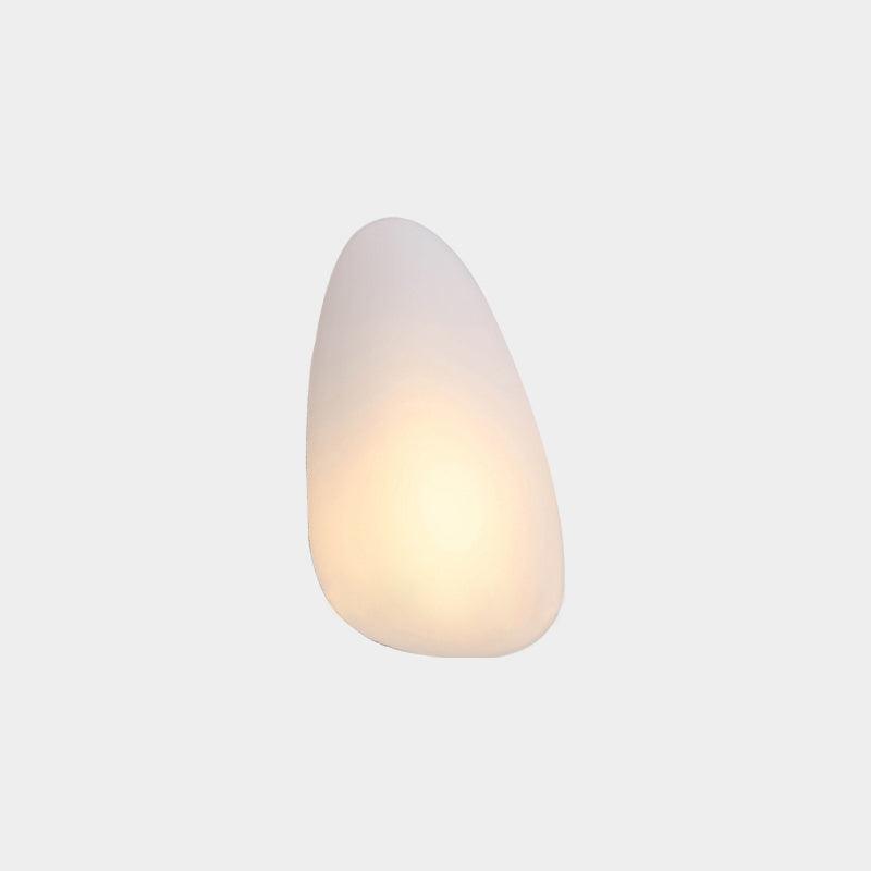 Clérachic Bubble Glass Wall Sconce in white, the teardrop Model B, with warm light pooling into the wider lower half of the shade.