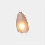 Amber Clérachic Bubble Glass Wall Sconce in the teardrop shape, a small bright point of warm light sitting low in the honey glass.