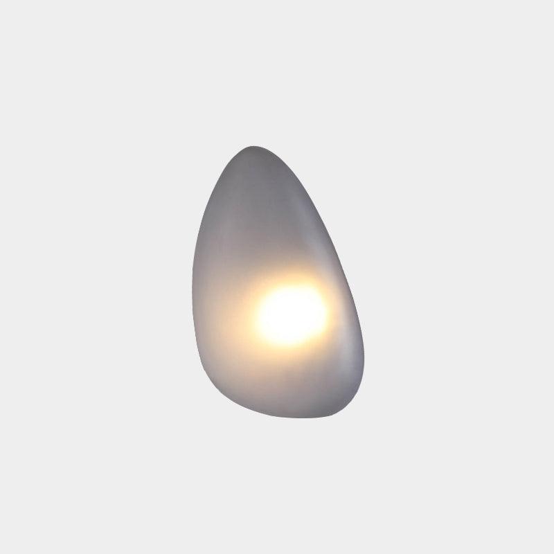 Clérachic Bubble Glass Wall Sconce in smoky gray, teardrop shape, with the warm bulb glowing near the base of the frosted shade.