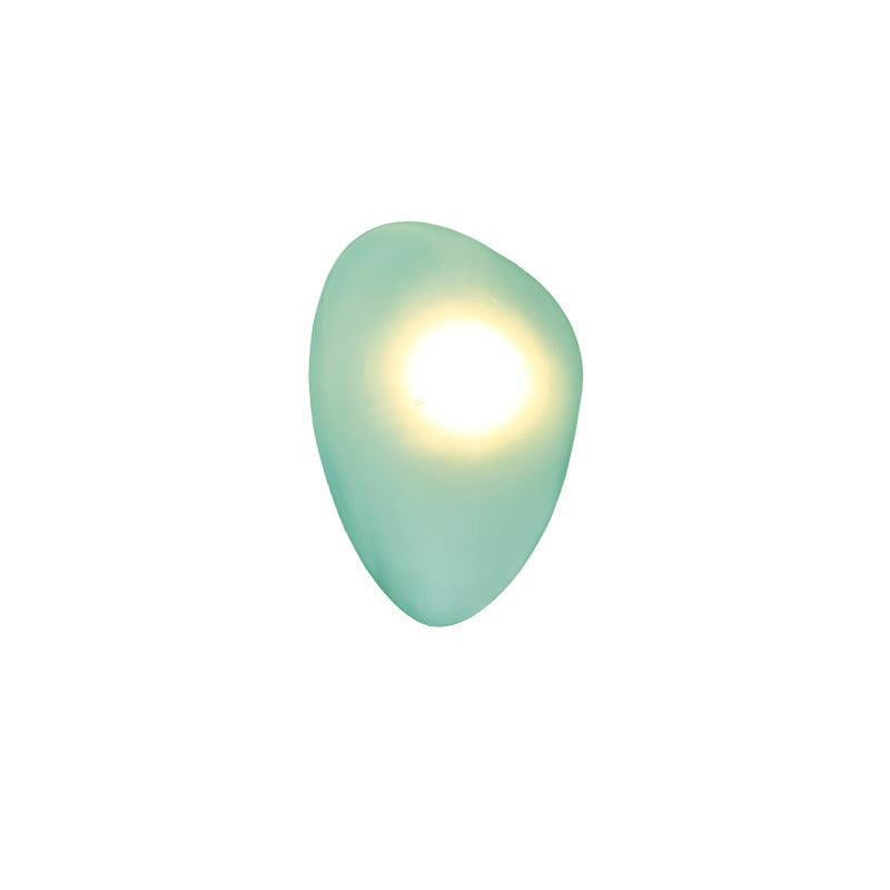 Green Clérachic Bubble Glass Wall Sconce in the rounded pebble shape, its warm centre sitting high and paling the sea-green glass.