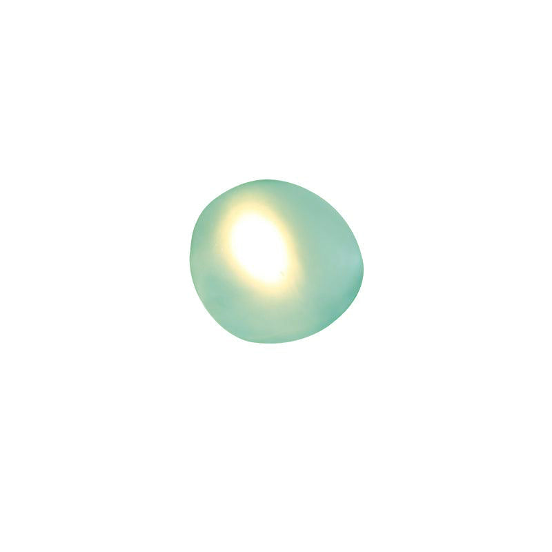 Clérachic Bubble Glass Wall Sconce in green, squat round shape, its oval warm glow set left of centre in the sea-green glass.
